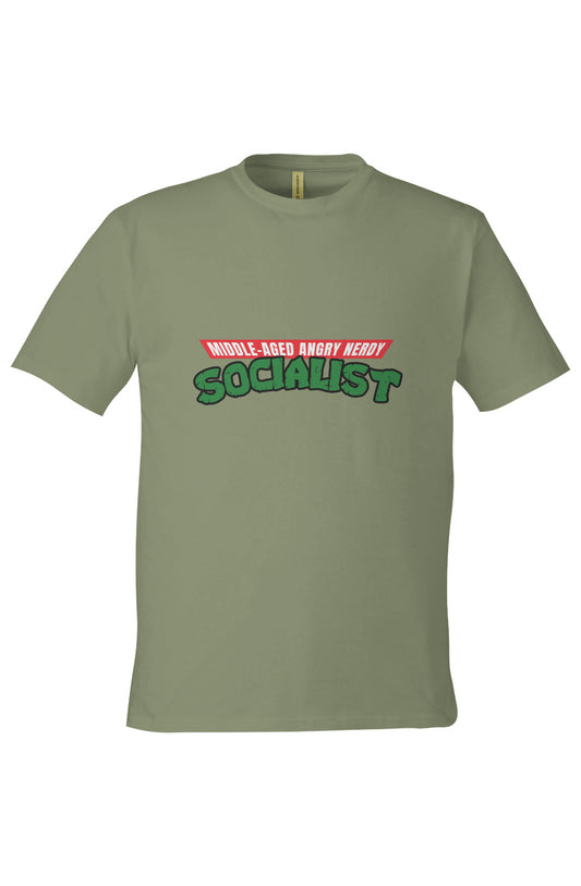 Light olive green t-shirt featuring a parody design styled after the Teenage Mutant Ninja Turtles logo. The top red banner reads “MIDDLE-AGED ANGRY NERDY” in white capital letters, and the word “SOCIALIST” is displayed below in large, cracked green lettering with a black outline.
